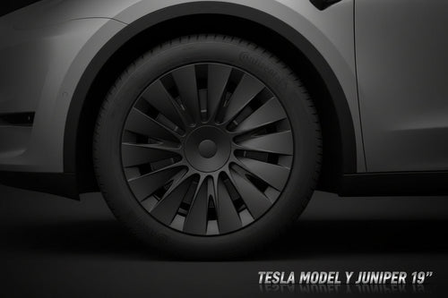 Close-up of a car wheel with a black rim and tire on a vehicle.