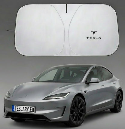A silver Tesla car shown with a large white car sun shade above it and a folded view of the shade to the left. The sun shade has a black Tesla logo printed on it.